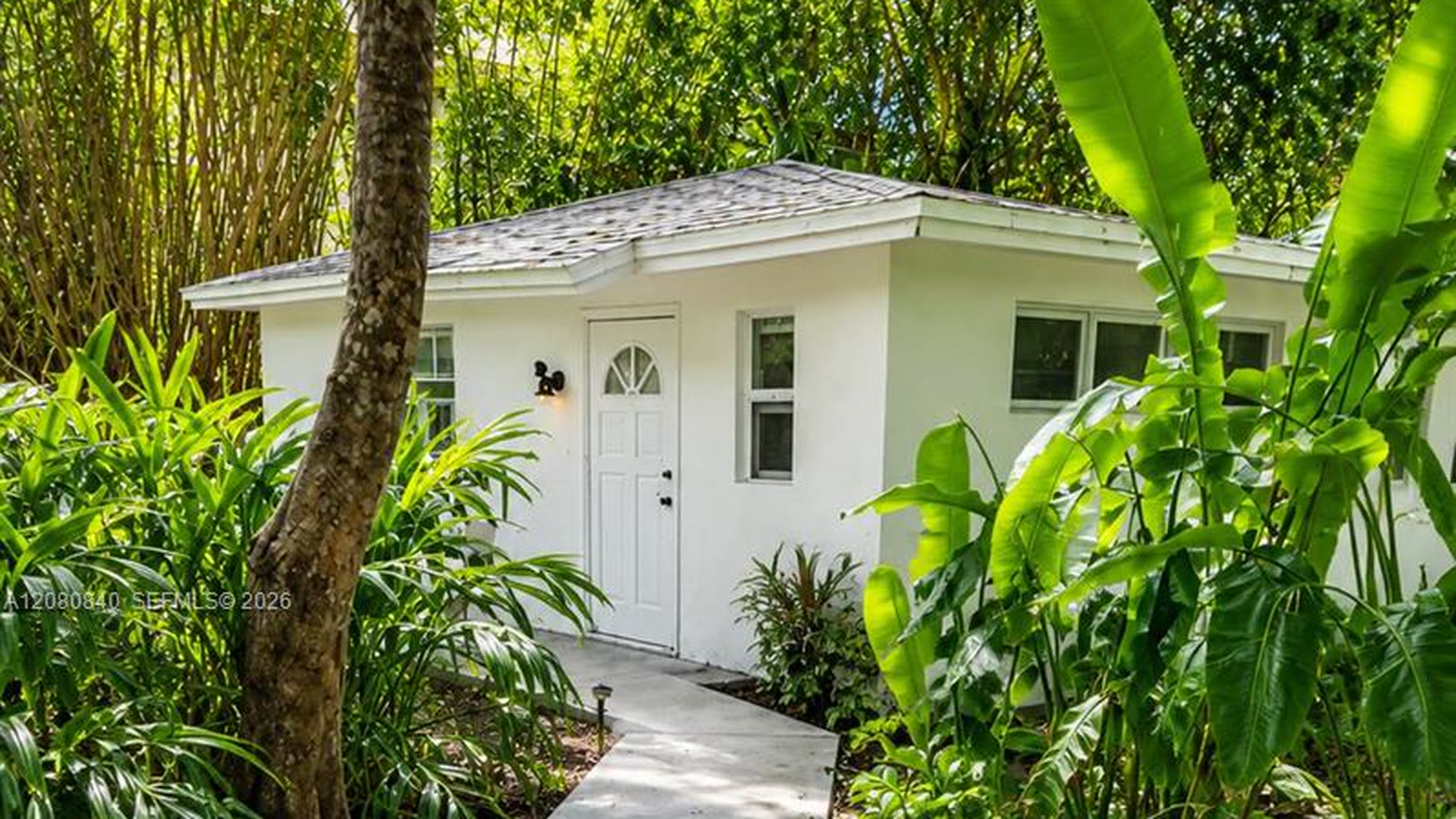 Entry walk and tropical planting at 4790 SW 65th Avenue, Davie